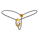 A gold-colored clitoral stimulator with a curved design and a rolling bead, attached to an adjustable black strap with a buckle.
