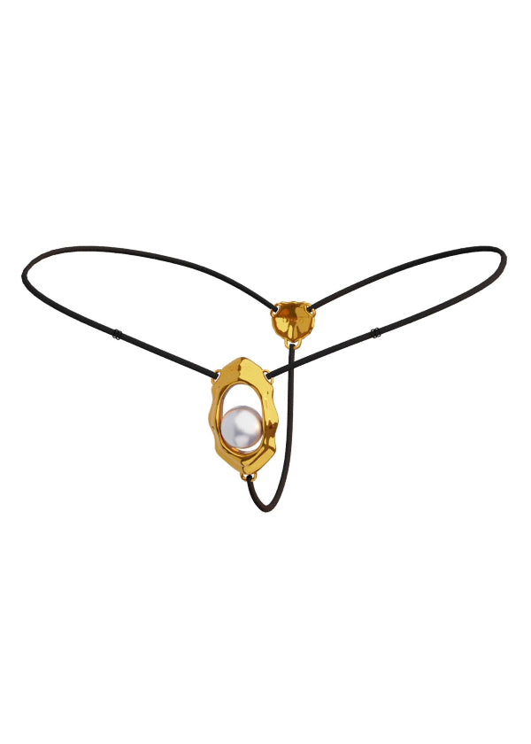 A gold-colored clitoral stimulator with a curved design and a rolling bead, attached to an adjustable black strap with a buckle.