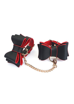 Liebe Seele Leather Bow Tie Wrist Cuffs with detachable gold hook chain in Black Red — leather — flat lay